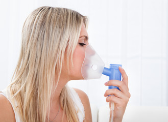 Woman with asthma inhaler