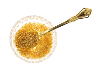 Glass beads in bowl with spoon