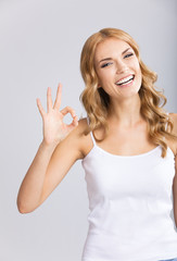 Young woman showing okay gesture