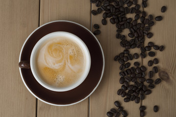 cup of coffee on wooden background