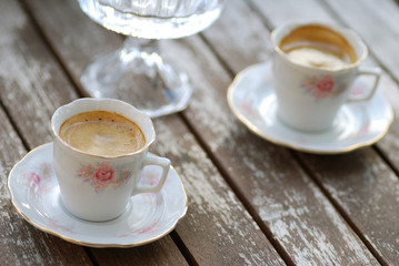 cups with flower pattern and gold lining with espresso