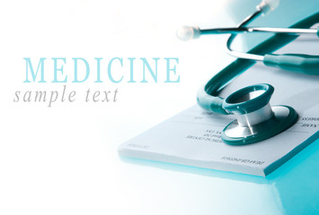 Empty medical prescription with a stethoscope on blue