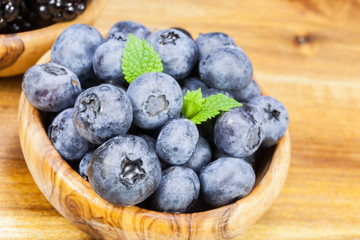 Blueberry. Blueberries  in olive wood bowl, close up