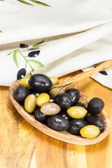 Foto op Plexiglas Olives in olive wood bowl with olive picker © happyimages