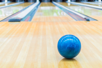 Blue bowling ball with Bowling alley.