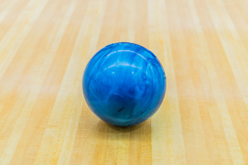 Blue bowling ball with Bowling alley.