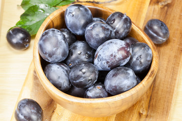 Fresh plums on wooden table