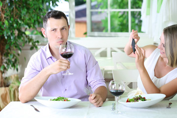 Young couple  taking  photo with  mobile phone in restaurant