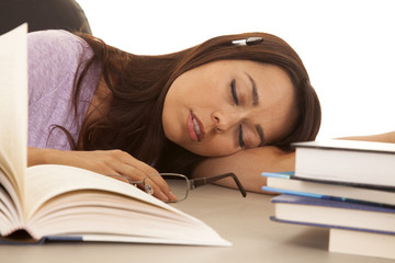 woman purple shirt asleep pen in ear books
