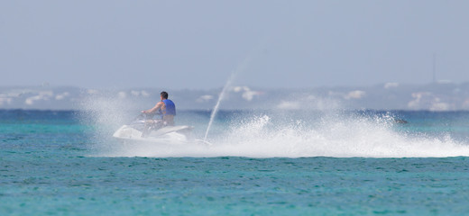 Obraz premium Cruising on the Caribbean Sea on a jet ski