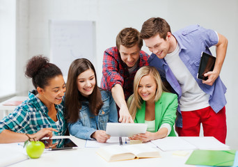 students looking at tablet pc at school