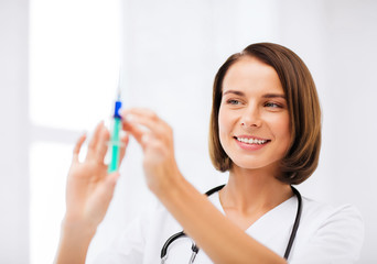 female doctor holding syringe with injection