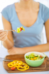 Obraz na płótnie Canvas woman hand holding fork with vegetables