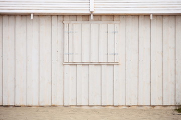 Obraz na płótnie Canvas white wooden building wall on beach