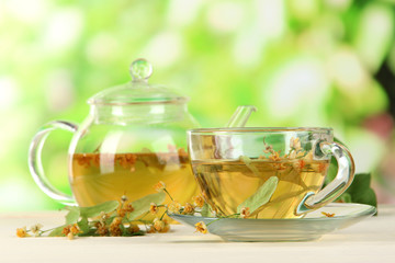 Kettle and cup of tea with linden