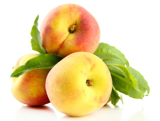 Ripe sweet peaches with leaves, isolated on white