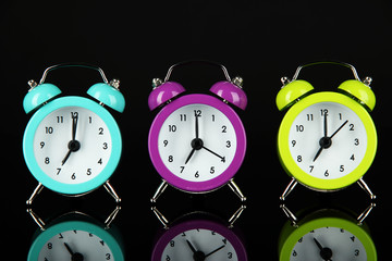 Colorful alarm clock on dark grey background