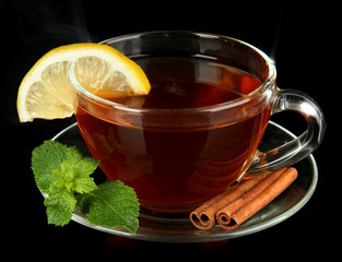 Cup of tea with lemon isolated on black