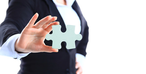 Business woman holding a piece of puzzle