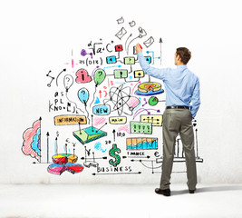 Businessman drawing sketches on wall