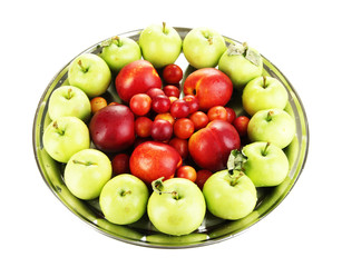 Assortment of juicy fruits on plate, isolated on white