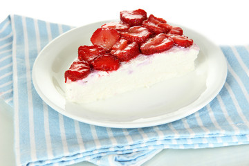 Cheesecake with fresh berries on white plate closeup