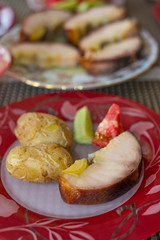 Smoked sturgeon fillets served with potatoes