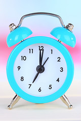 alarm clock on table on light background