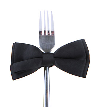 Black bow tie  on fork, isolated on white