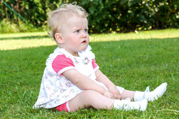 Baby sitting alone in the meadow