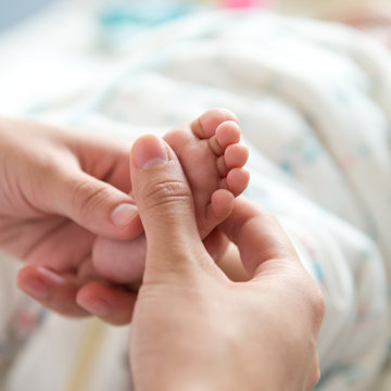 massaging little baby's foot