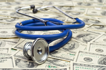 heap of dollars with stethoscope - 54835028