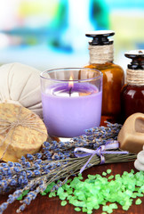 Fototapeta na wymiar Still life with lavender candle, soap, massage balls, bottles,