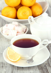 Cup of tea with lemon on table close-up
