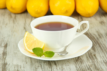 Cup of tea with lemon on table close-up