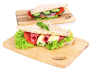 Tasty sandwiches with salami sausage and vegetables