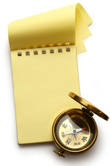Blank yellow notepad with compass