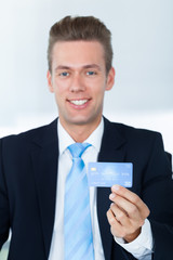 Portrait Of Young Happy Businessman Holding Credit Card