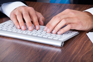 Businessman Typing On Computer Keyboard