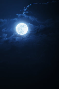 Fototapeta Dramatic Nighttime Clouds and Sky With Beautiful Full Blue Moon