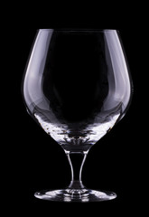 Cognac or brandy empty glass on a black