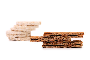 Two stacks. Puffed rice snack and crisp bread.