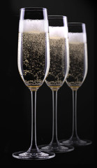 glass of champagne isolated on black background