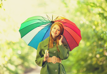 Redhead girl with umbrella at outdoor