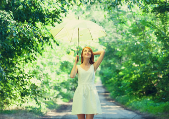 Redhead girl with umbrella at outdoor