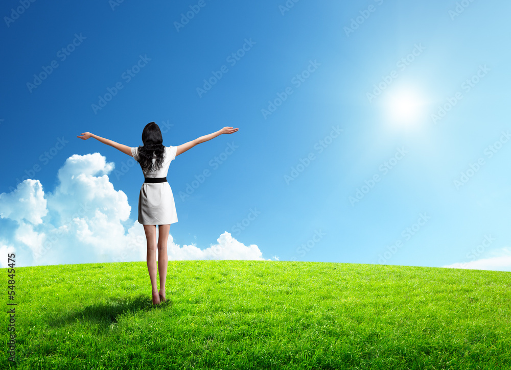 Wall mural field of grass and happy young woman