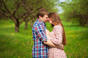 Happy loving coupleare hugging on a spring meadow