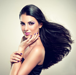 Naklejka premium Beautiful brunette with long hair flying