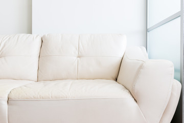 white sofa near glass partition