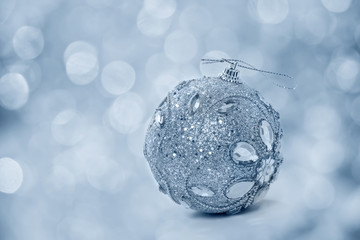 Christmas ball on the shining background